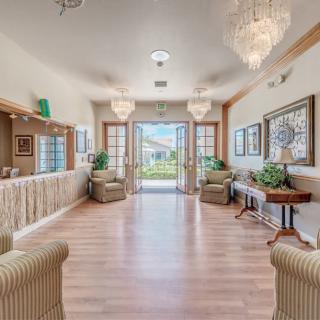 A spacious and elegantly designed lobby with comfortable seating and large chandeliers.