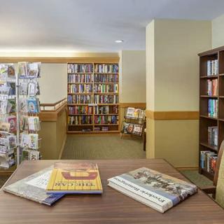 An inviting library space with bookshelves and a reading table.