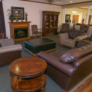A cozy living room with leather sofas and a fireplace.