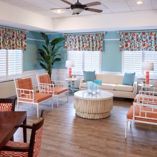 A brightly decorated living room with comfortable seating and vibrant accents.
