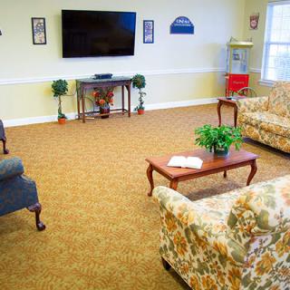 A cozy living room with comfortable seating and a large television.