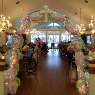A beautifully decorated archway welcoming residents to a festive gathering in the activity center.