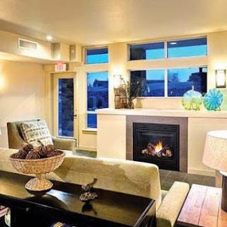 A cozy and modern living room featuring a fireplace and stylish decor, perfect for relaxation.