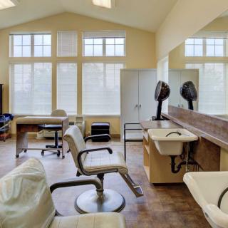 Interior view of a hair salon with styling chairs and equipment.