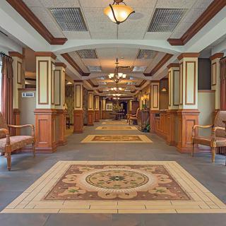 A well-lit, elegantly designed hallway with decorative elements and wood paneling.