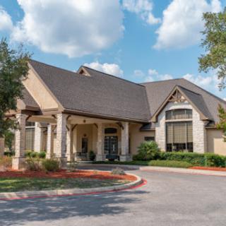 A beautifully designed building featuring modern architectural elements, surrounded by landscaped greenery.