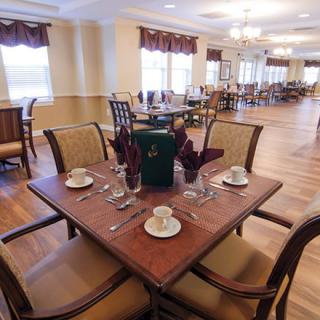 An elegantly set dining table in a spacious restaurant interior.
