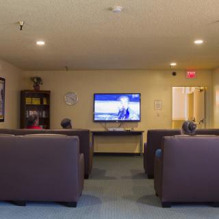 A cozy lounge area with comfortable seating and a television.