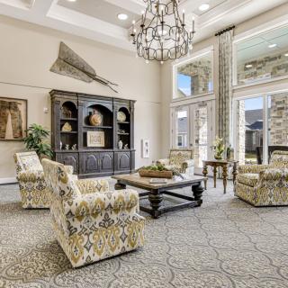 Elegant living room with a grand chandelier and stylish furnishings.