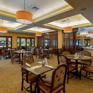 An elegant restaurant dining area with neatly arranged tables and ambient lighting.