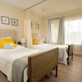 A cozy bedroom with twin beds and ample natural light.