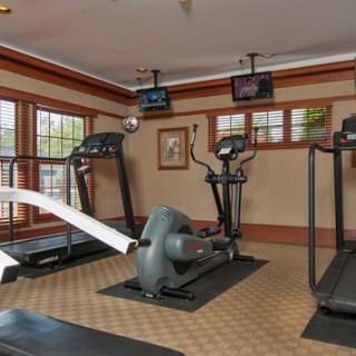 A well-equipped indoor gym with treadmills and an elliptical machine.
