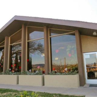 Modern restaurant exterior with large windows.