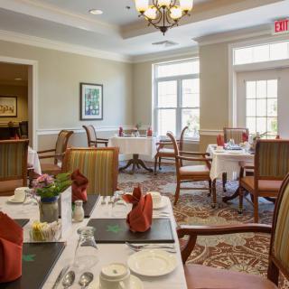 Elegant dining room with neatly arranged tables and chairs, ready for guests.