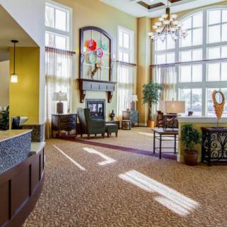 Spacious lobby with large windows, comfortable seating, and elegant lighting.