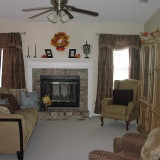 A cozy living room with a fireplace and comfortable seating.