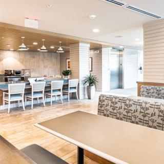 A modern dining area featuring sleek tables, comfortable seating, and decorative pendant lighting.