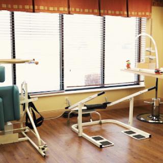 A physical therapy treatment room featuring exercise equipment.