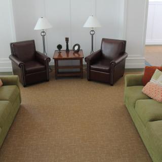 A cozy living room setup featuring two sofas, two armchairs, a coffee table, and floor lamps.