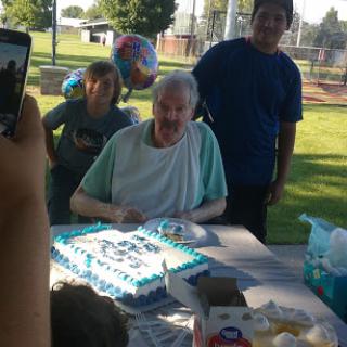 A joyful birthday celebration in the park with family and friends.