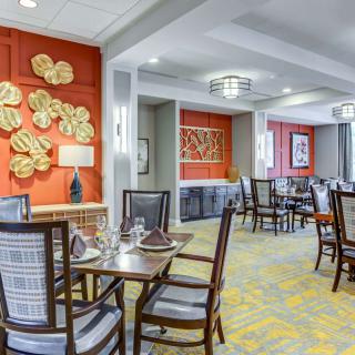 A stylish dining room with elegant furnishings and decorative wall art.
