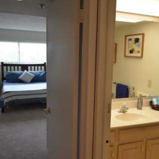 A view of a bedroom with an adjacent bathroom.
