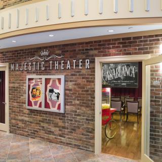 Entrance to the Majestic Theater featuring posters and decorative lighting.