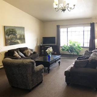 A cozy living room with comfortable seating and natural lighting.