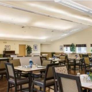 An indoor dining room with neatly arranged tables and chairs.