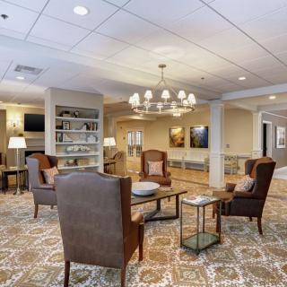 Elegant lobby with plush seating and a chandelier.