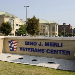 The Gino J. Merli Veterans Center with its entrance sign and building in view.