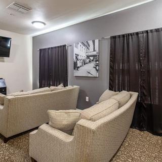 A modern living room with comfortable couches, wall art, and a TV.