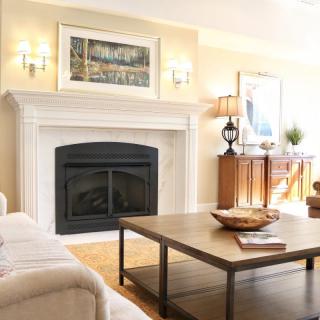 A cozy living room featuring a fireplace, comfortable sofa, and stylish coffee table.