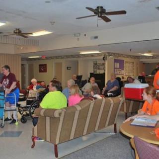 A group of people gathered in an indoor seating area, socializing and spending time together.
