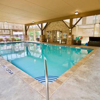 An inviting indoor swimming pool area with clear water and spacious surroundings.