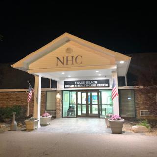 The entrance of NHC illuminated at night.
