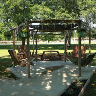 A serene outdoor gazebo surrounded by greenery, perfect for relaxation.