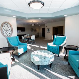A modern lobby with turquoise seating and a stylish coffee table.