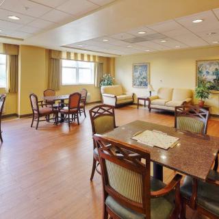 A spacious dining area with wooden furniture and natural lighting.