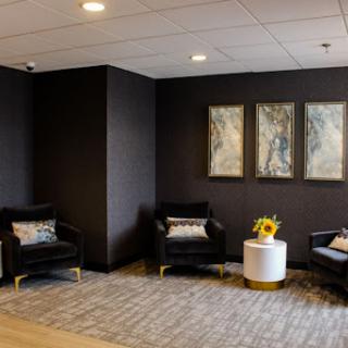 A stylish and modern waiting area featuring comfortable seating, contemporary artwork, and a welcoming atmosphere.