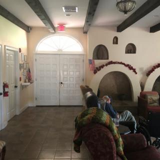 A cozy living room featuring archways, a comfortable sofa, and warm lighting.