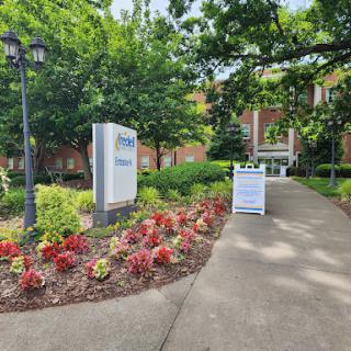 A welcoming entrance with colorful flowers leading to a building.