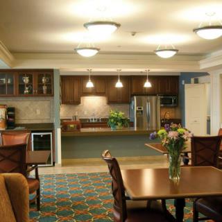 A modern kitchen and dining area with warm lighting and contemporary furnishings.