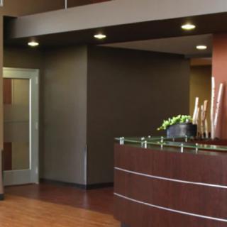 A modern reception area with sleek design elements and a curved front desk.
