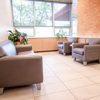 A modern waiting area featuring comfortable seating and natural light.