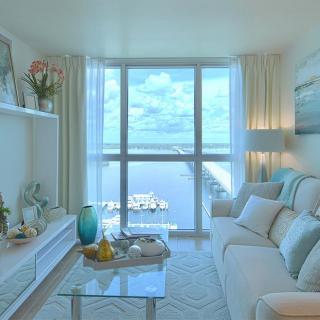 A modern living room with a stunning ocean view and cozy, elegant decor.