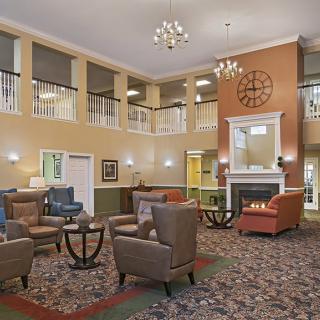 A cozy lobby area featuring comfortable seating and a warm fireplace.