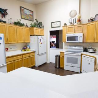 A spacious kitchen featuring oak cabinets, modern appliances, and a clean countertop.