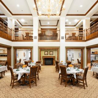 A luxurious dining room with elegant decor and a grand chandelier.