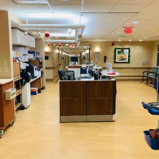 A view of the nurse station in a hospital, showcasing a clean and organized medical environment.